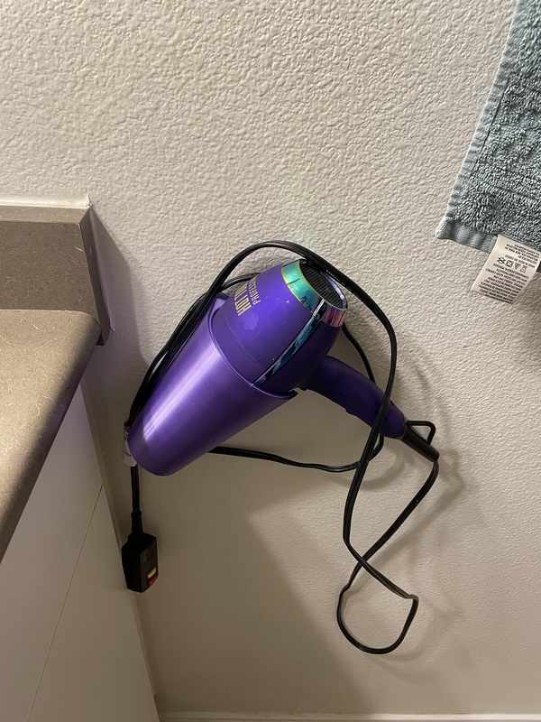 Hair dryer holster installed in the bathroom