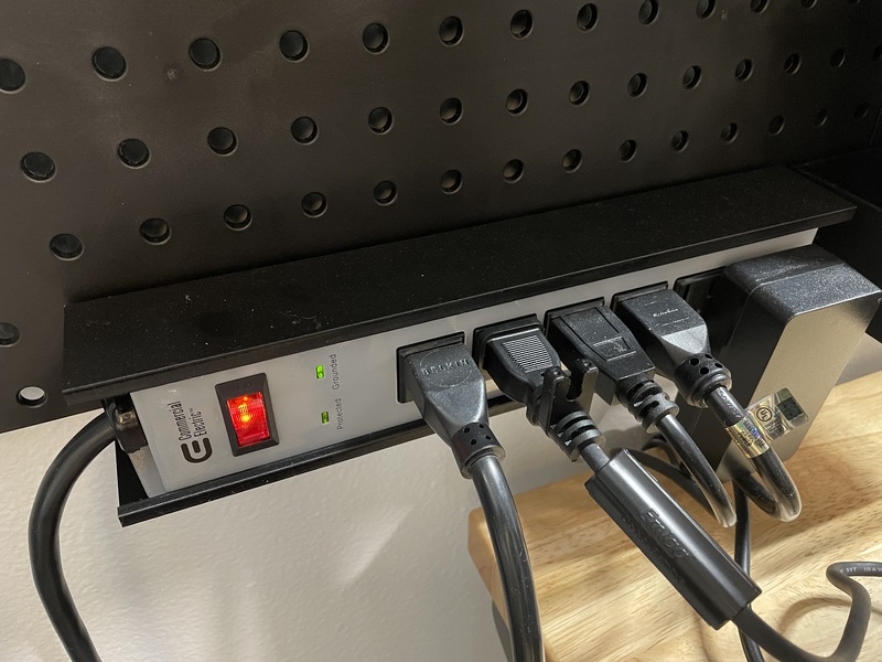 Surge protector attached to pegboard