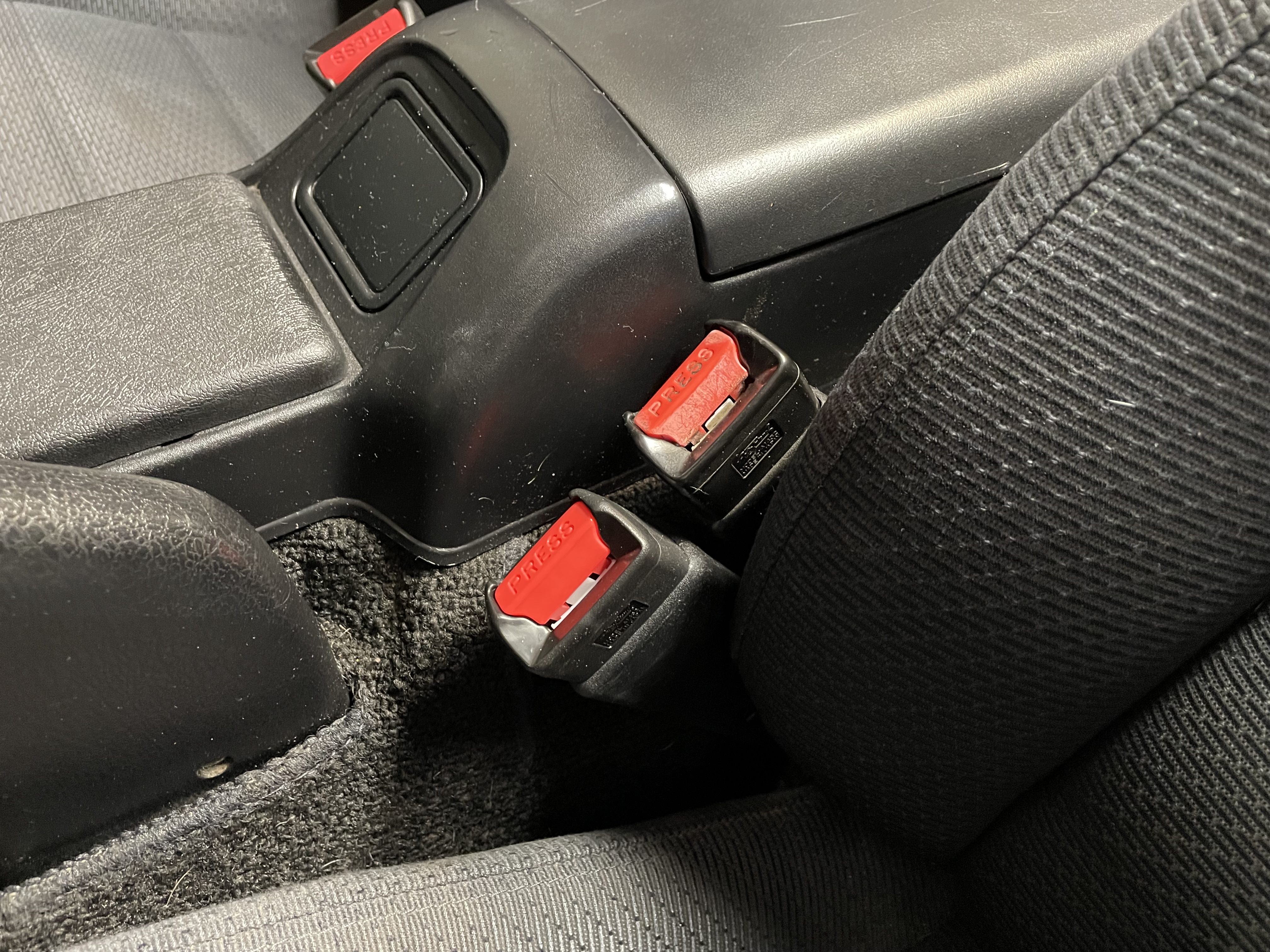 New seat belt receptacle installed with the old one positioned