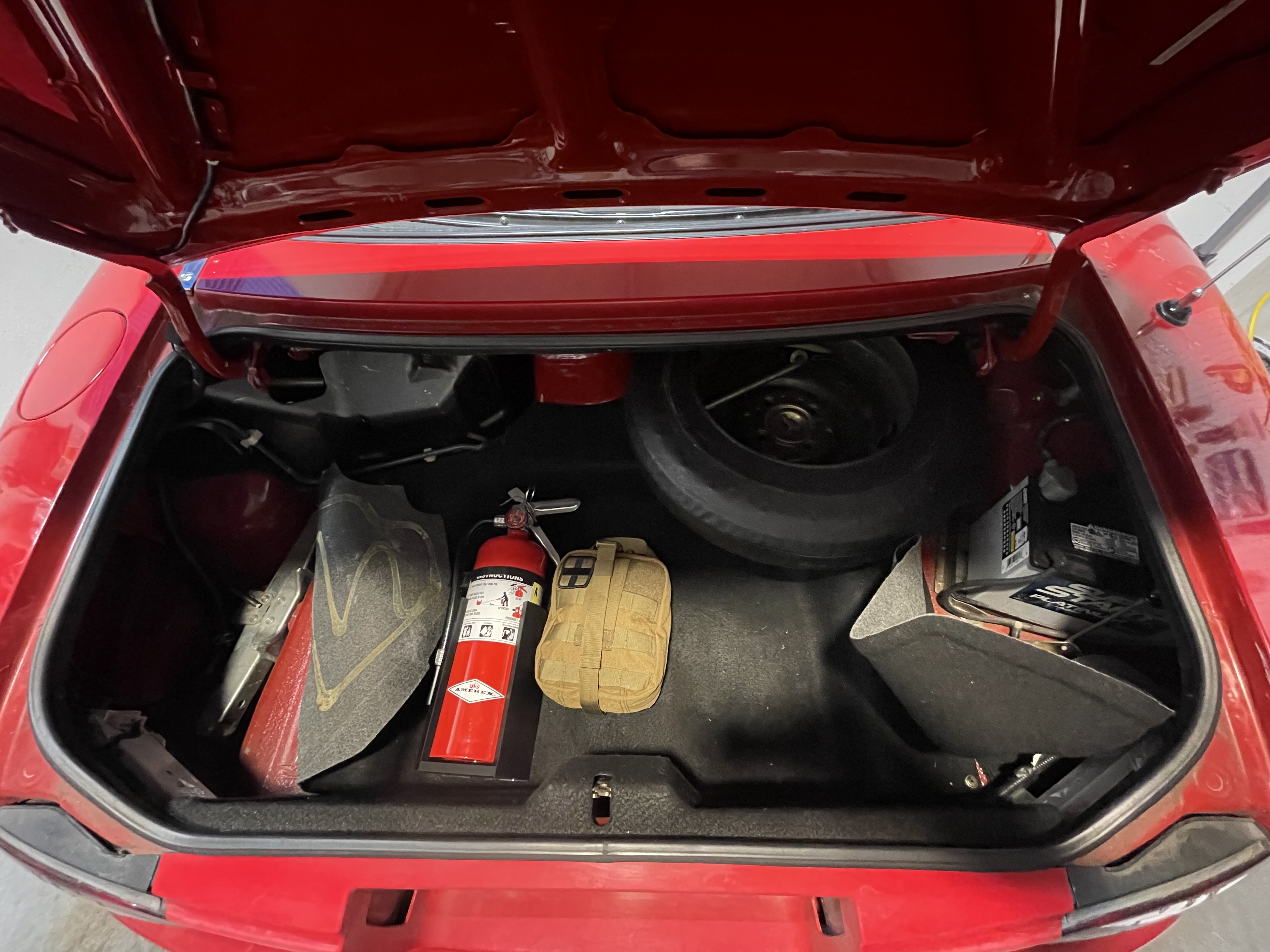 The trunk with the battery and jack revealed